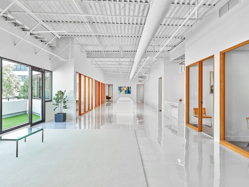 long bright hallway with glass doors looking into offices