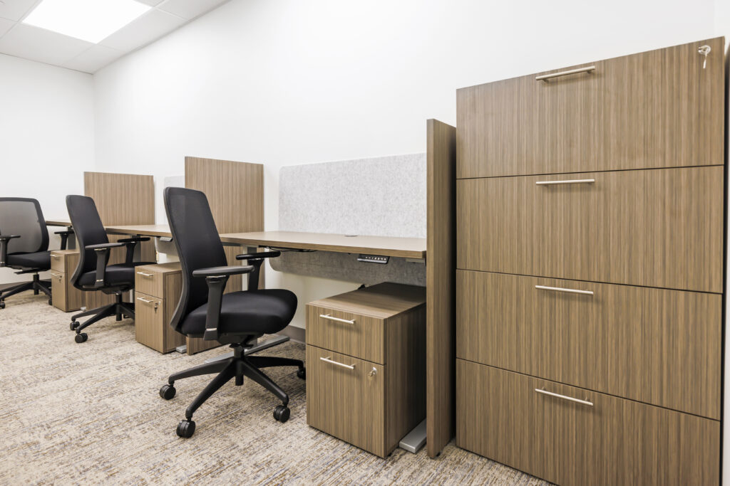 small office area with individal work areas in natural wood tones and rolling office chairs