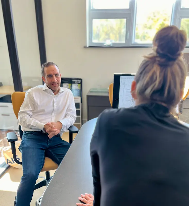 man and woman in an office engaged in conversation