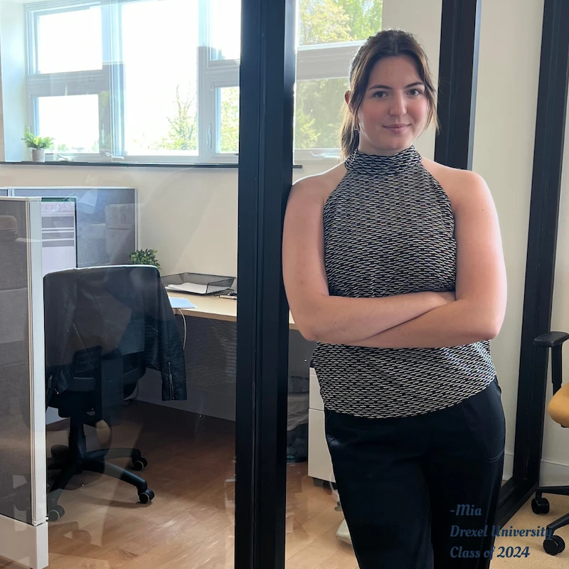 young women leaning against office wall