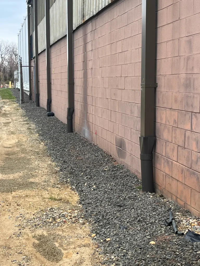 capped drains running vertically donw the side of a building