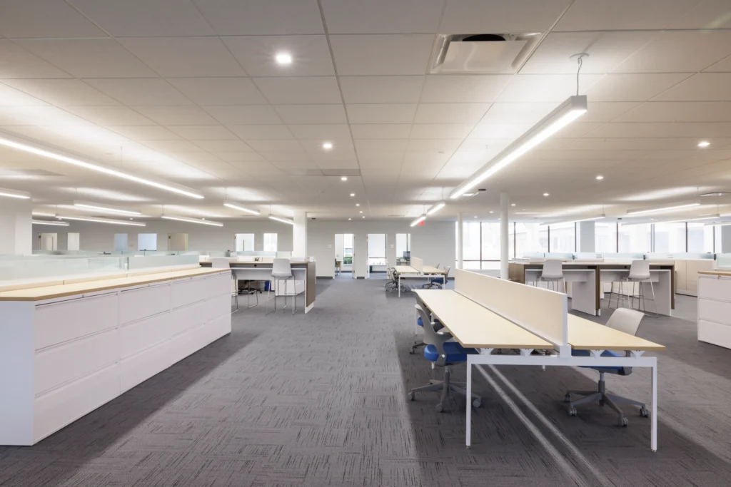 bright corporate office space with natural lighting and various flexible workspaces