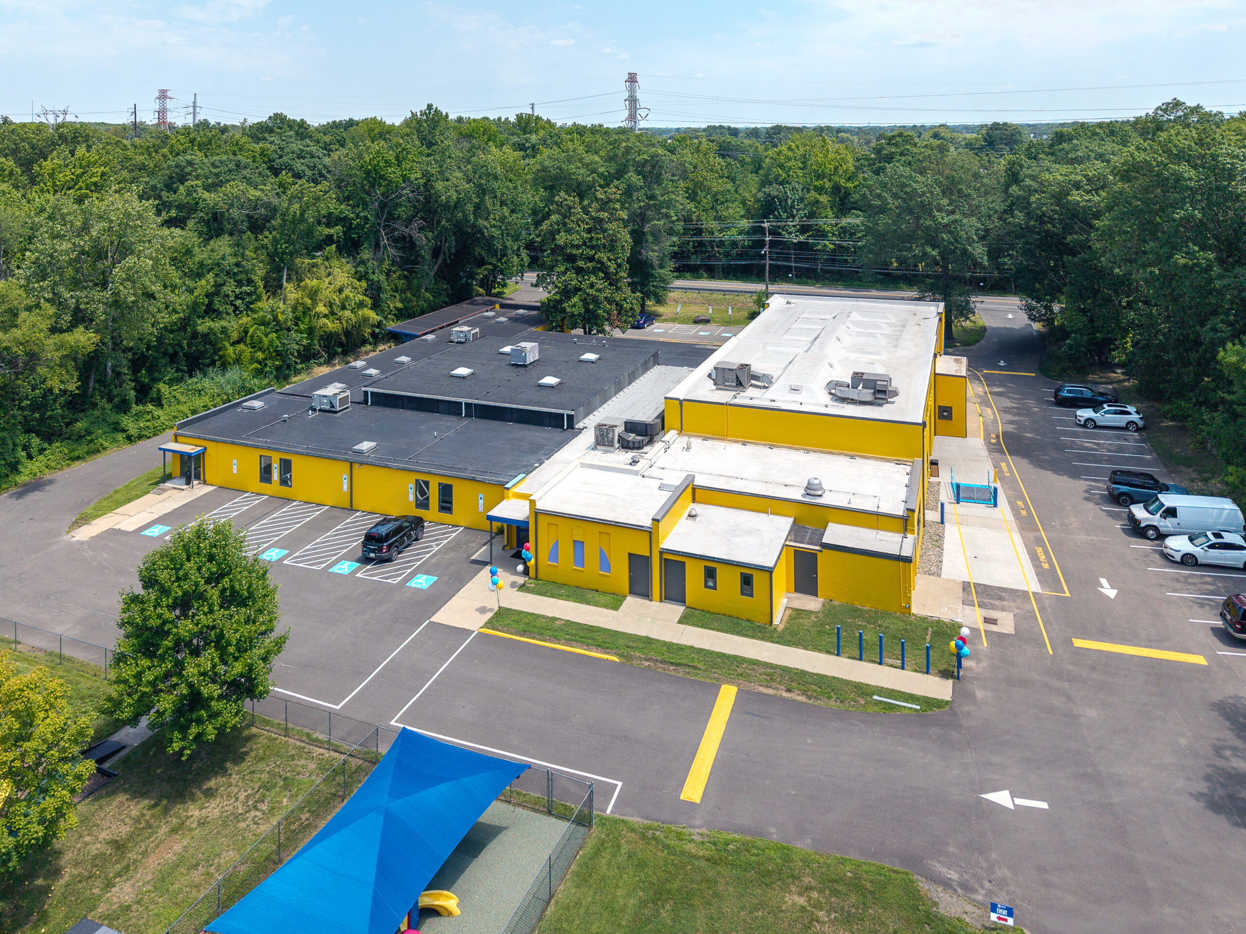 aerial photo of warehouse building with white and black roof